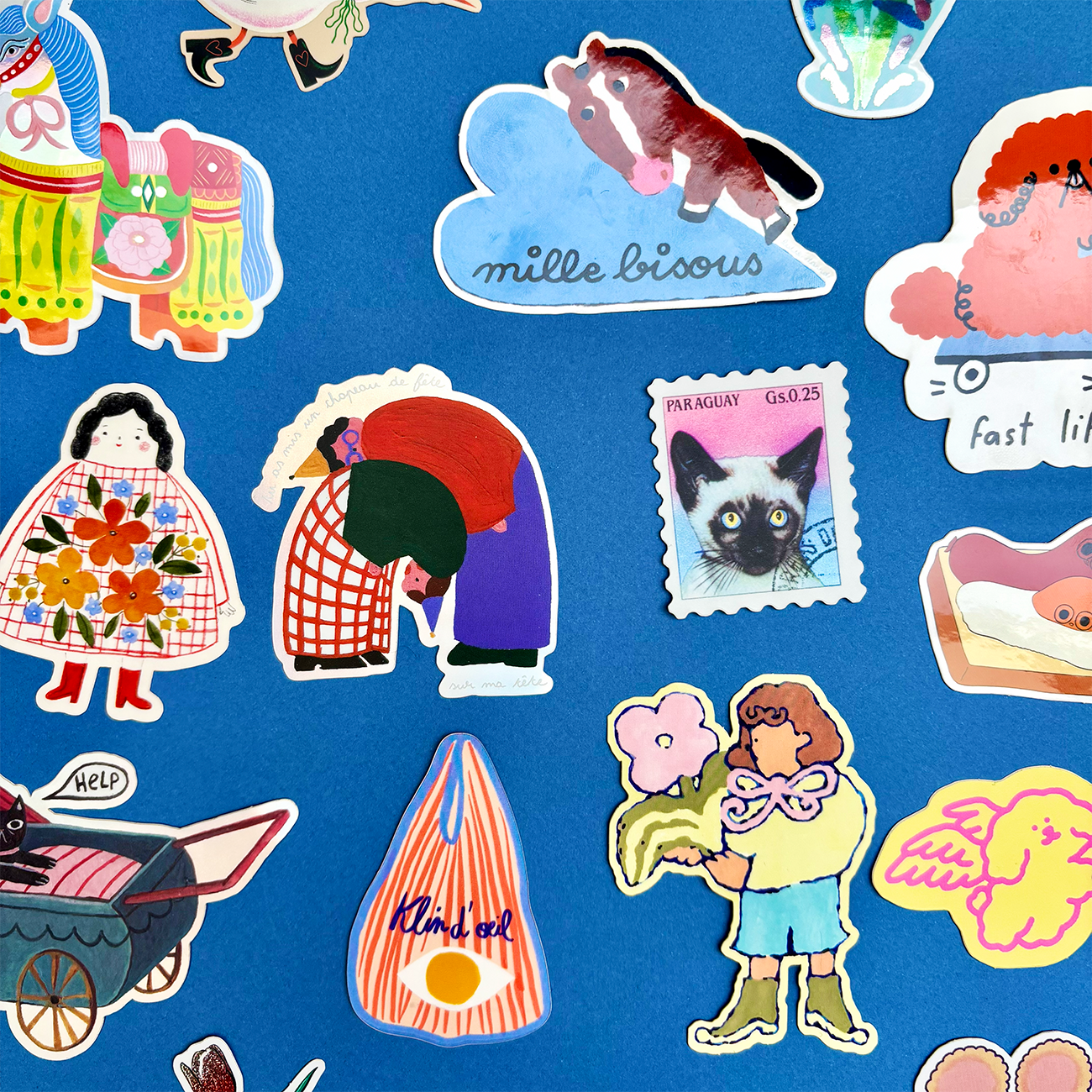 A collection of colorful, whimsical stickers on a blue background, featuring animals, people, and playful illustrations.